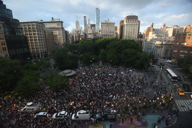 Wide shot of a large crowd of people at Washington Square Park.